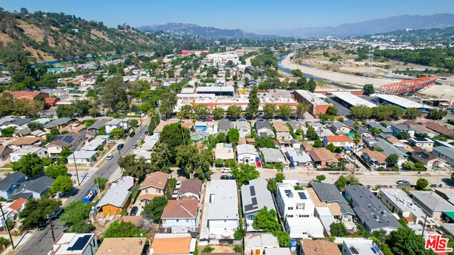an aerial view of residential houses with outdoor space