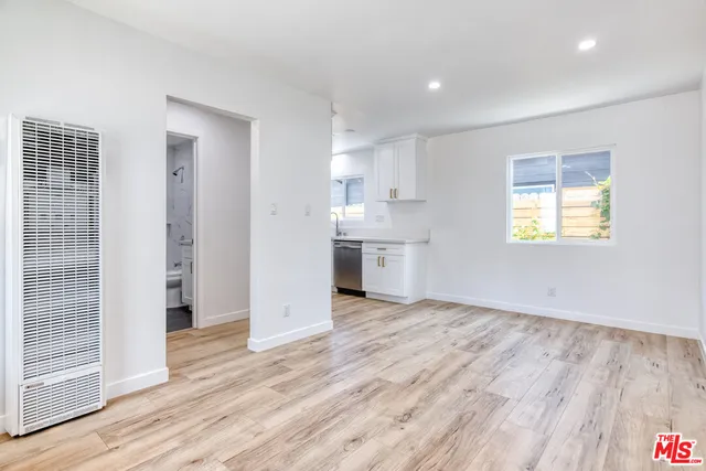 a view of a kitchen with wooden floor and a sink