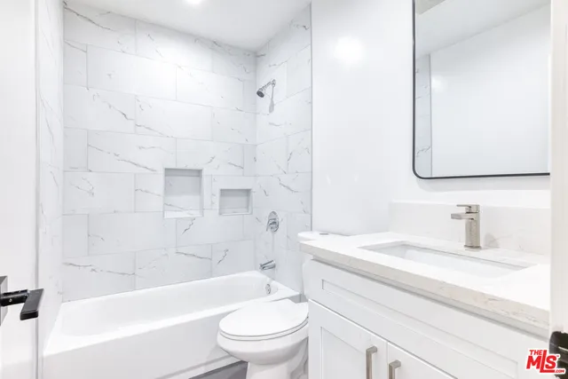 a bathroom with a sink a toilet and a bathtub