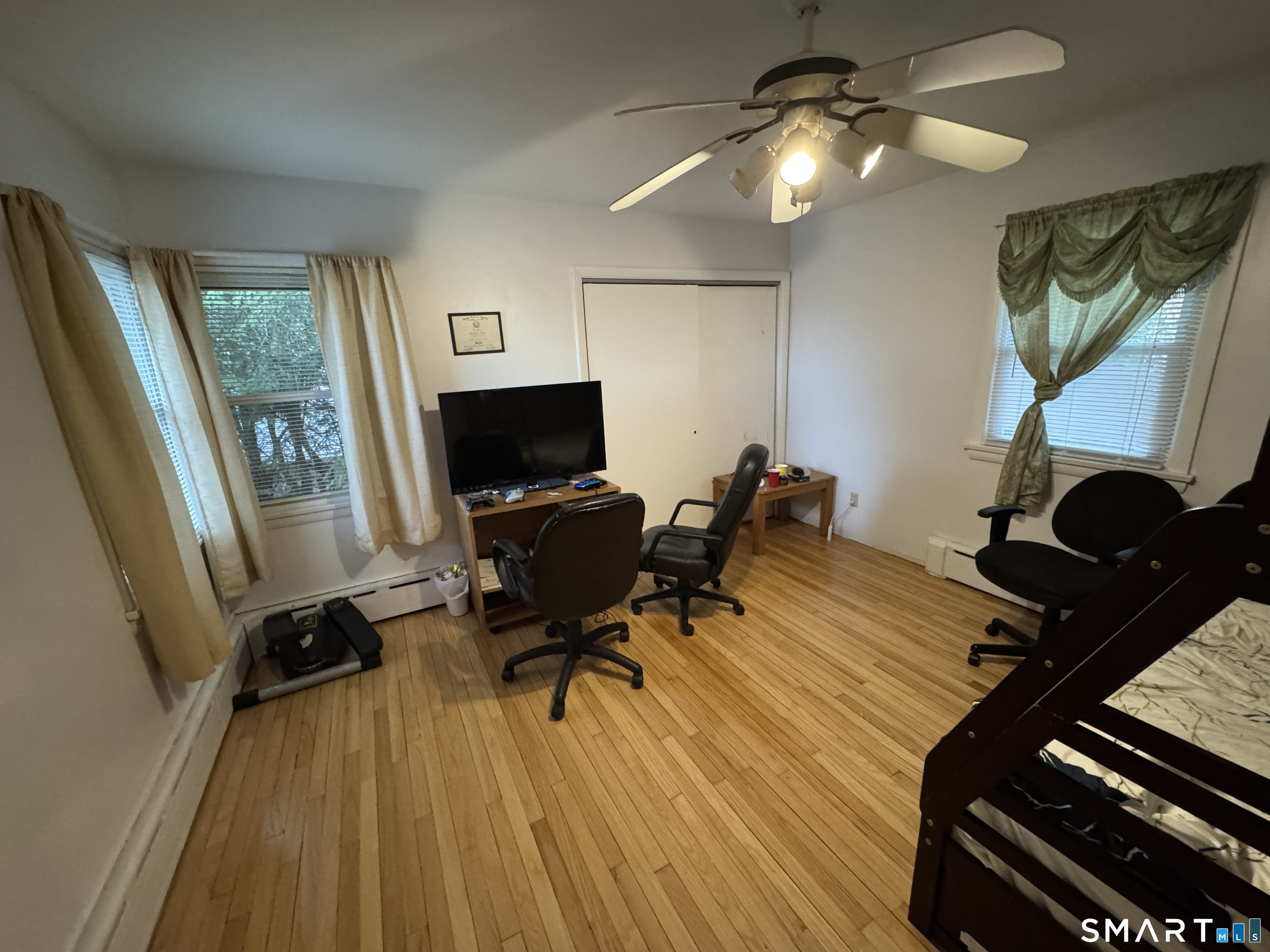 90 Larchmont Avenue Waterbury, CT 06708 - Photo 14 of 26 a view of a workspace with furniture and a window