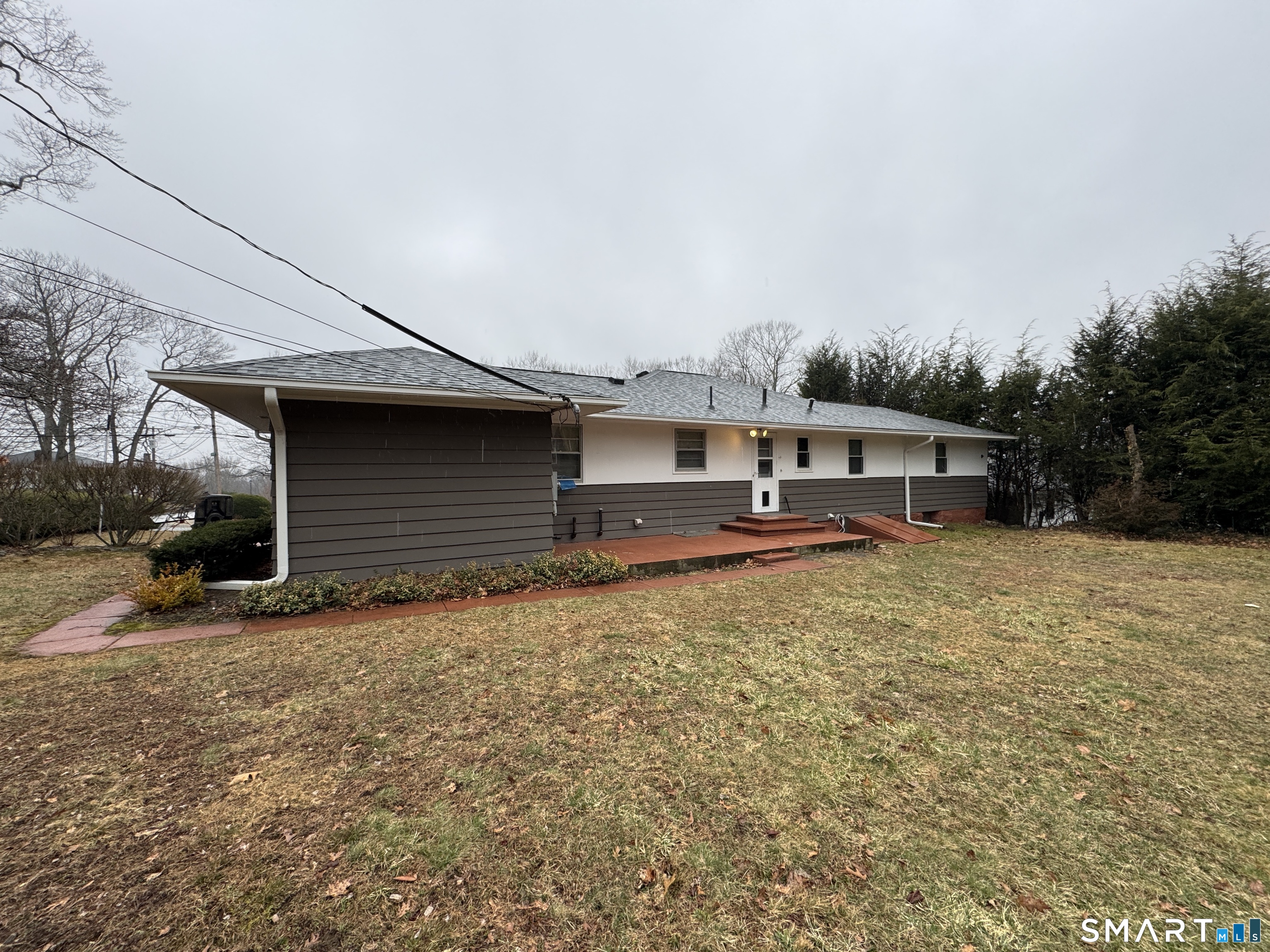 90 Larchmont Avenue Waterbury, CT 06708 - Photo 4 of 26 a front view of a house with a yard