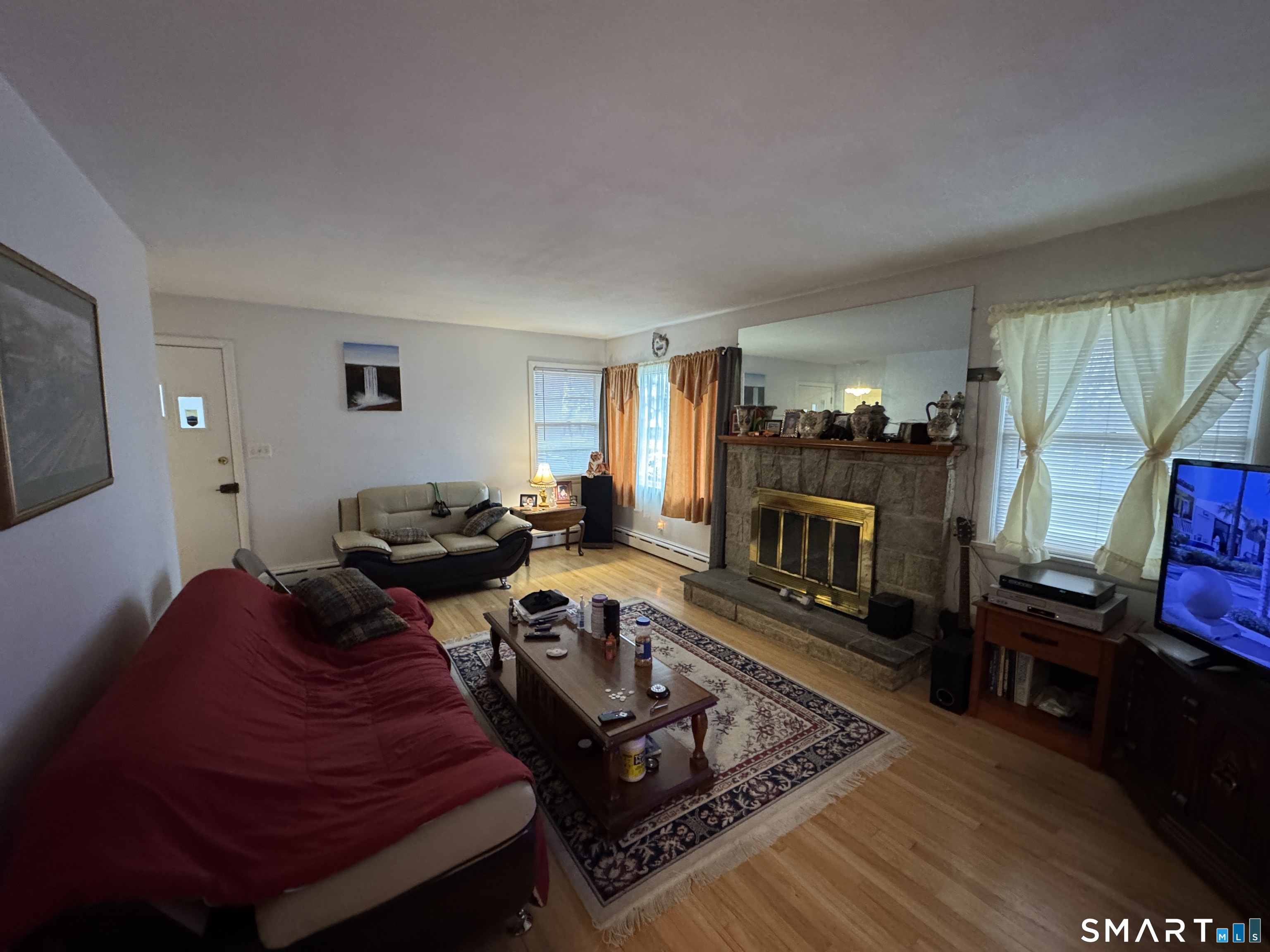 90 Larchmont Avenue Waterbury, CT 06708 - Photo 8 of 26 a living room with furniture and a flat screen tv