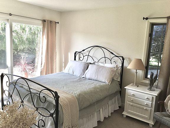 11394 Saddle Road Monterey, CA 93940 - Photo 11 of 33 a bedroom with a bed and a window in it