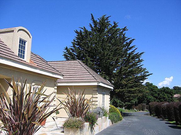 11394 Saddle Road Monterey, CA 93940 - Photo 17 of 33 a front view of a house with a yard and garage