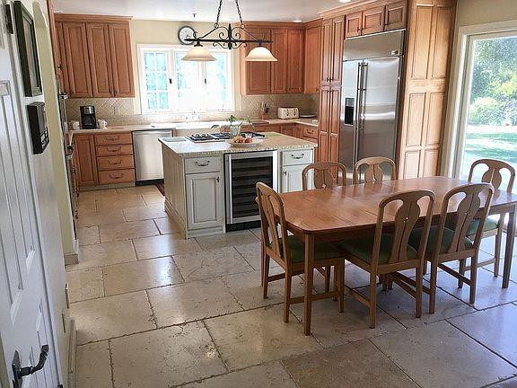 11394 Saddle Road Monterey, CA 93940 - Photo 2 of 33 a kitchen with a dining table chairs and refrigerator