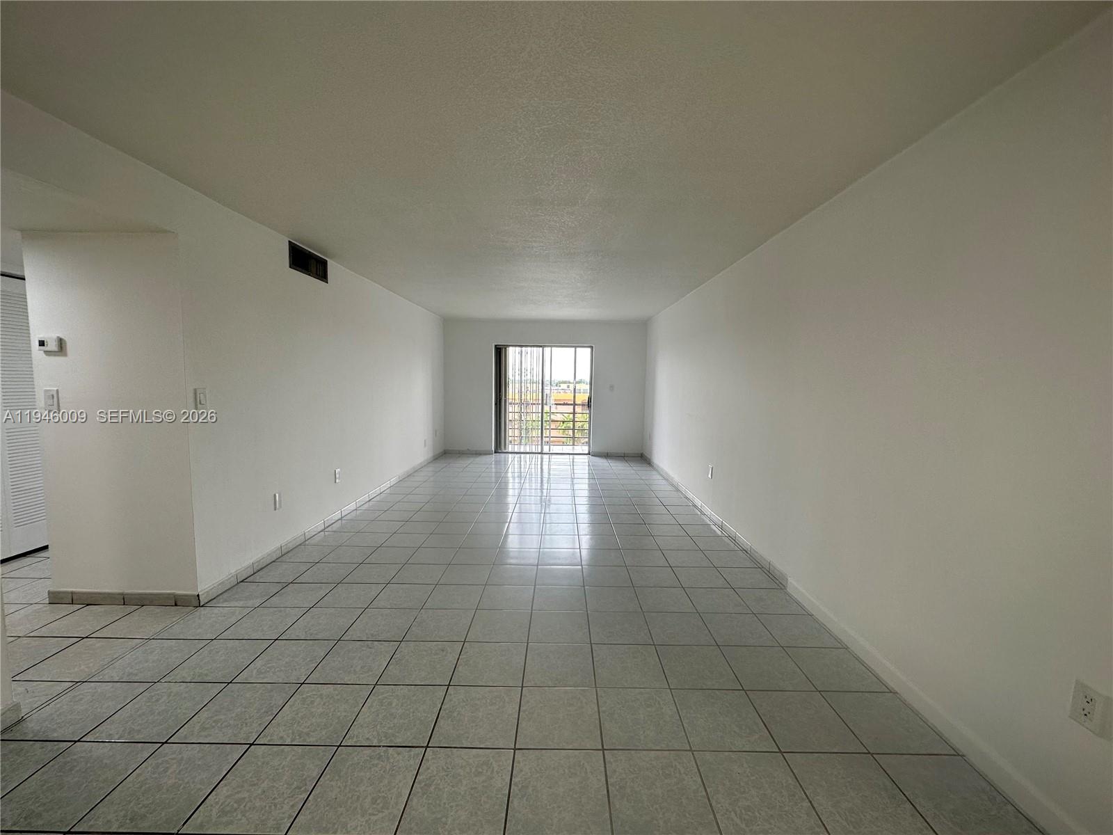 4670 West 13th Lane, Unit 405 Hialeah, FL 33012 - Photo 3 of 16 an empty room with windows