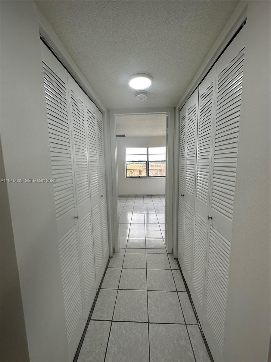 4670 West 13th Lane, Unit 405 Hialeah, FL 33012 - Photo 8 of 16 a view of an empty room and window