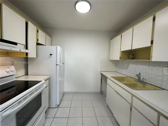 a kitchen that has a sink and a stove