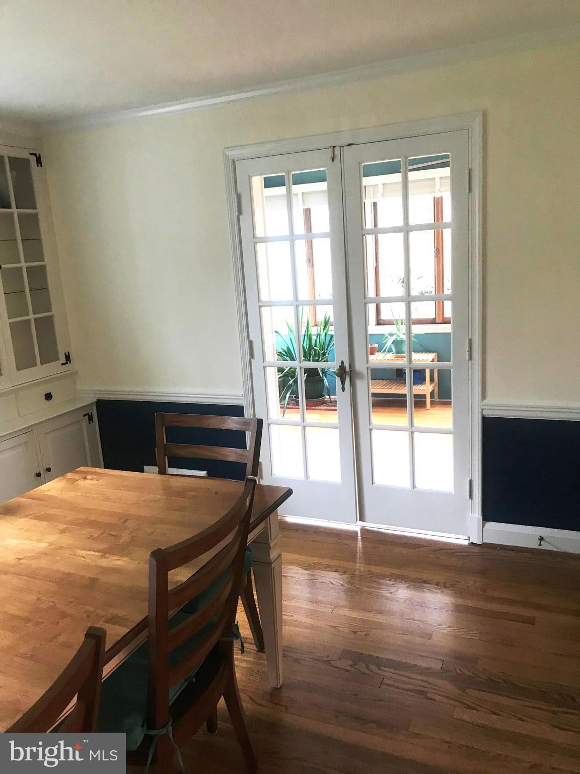 304 Cedarcroft Road Baltimore, MD 21212 - Photo 13 of 39 a dining room with wooden floor and a table