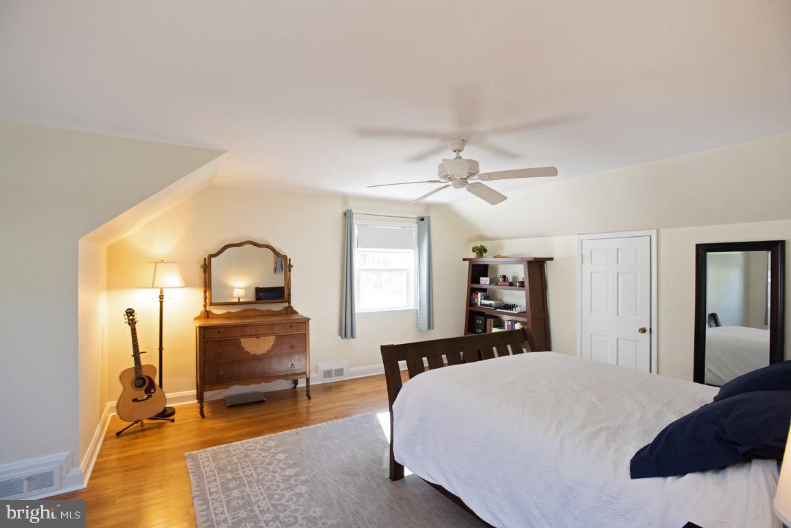 304 Cedarcroft Road Baltimore, MD 21212 - Photo 19 of 39 a bedroom with a bed and wooden floor