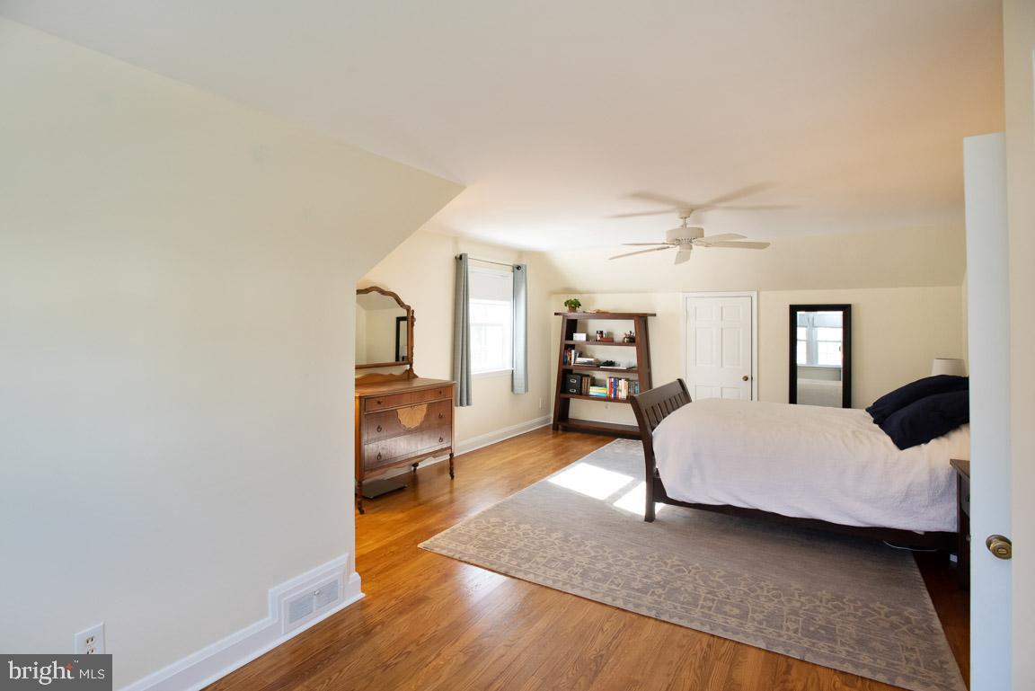 304 Cedarcroft Road Baltimore, MD 21212 - Photo 20 of 39 a bedroom with furniture and a wooden floor