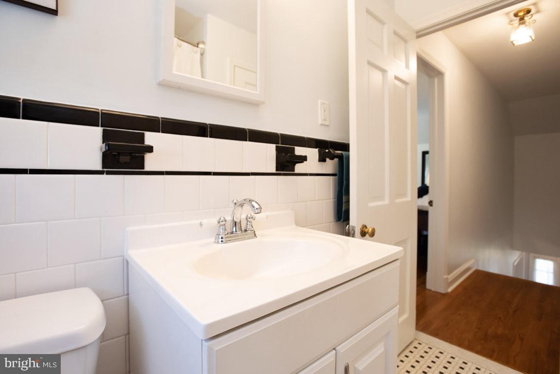 304 Cedarcroft Road Baltimore, MD 21212 - Photo 25 of 39 a bathroom with a sink and a toilet