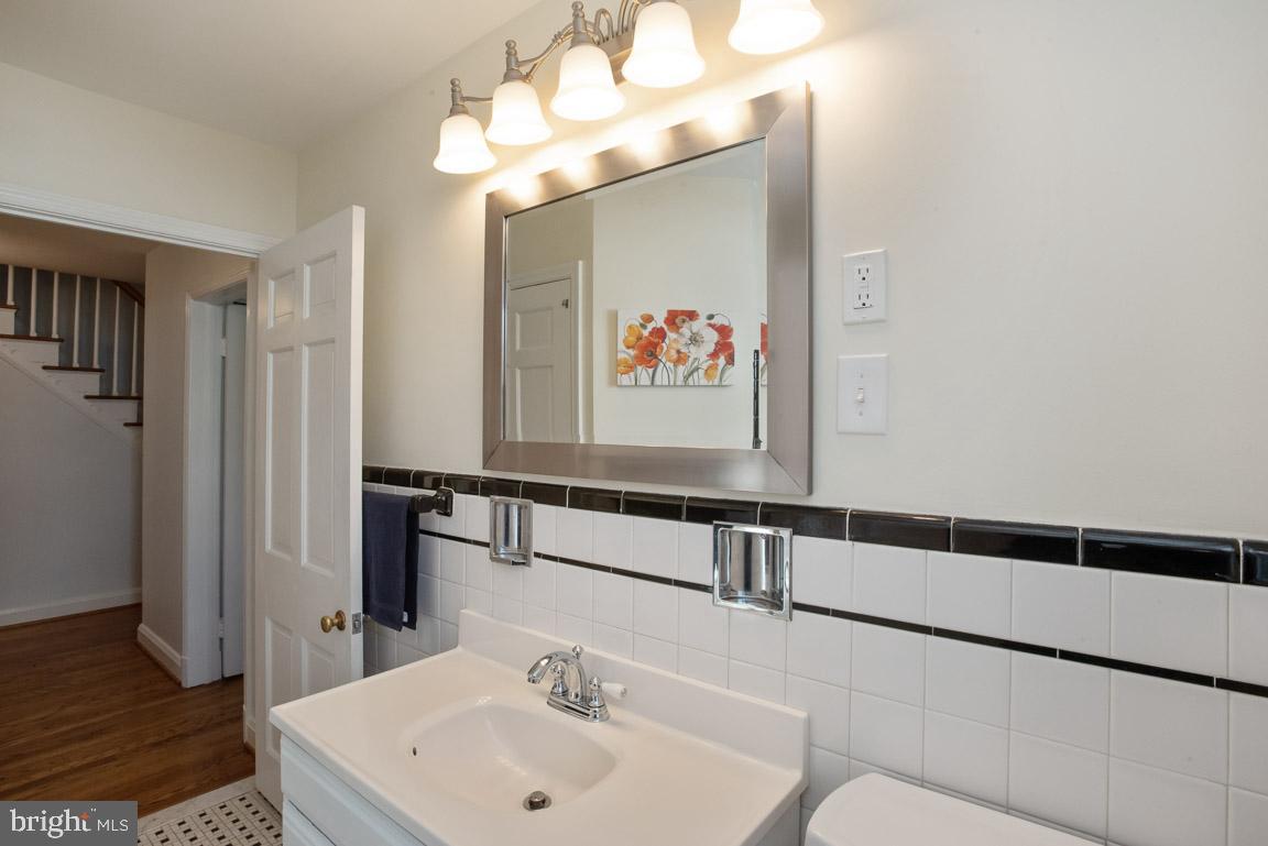 304 Cedarcroft Road Baltimore, MD 21212 - Photo 31 of 39 a bathroom with a sink and a mirror