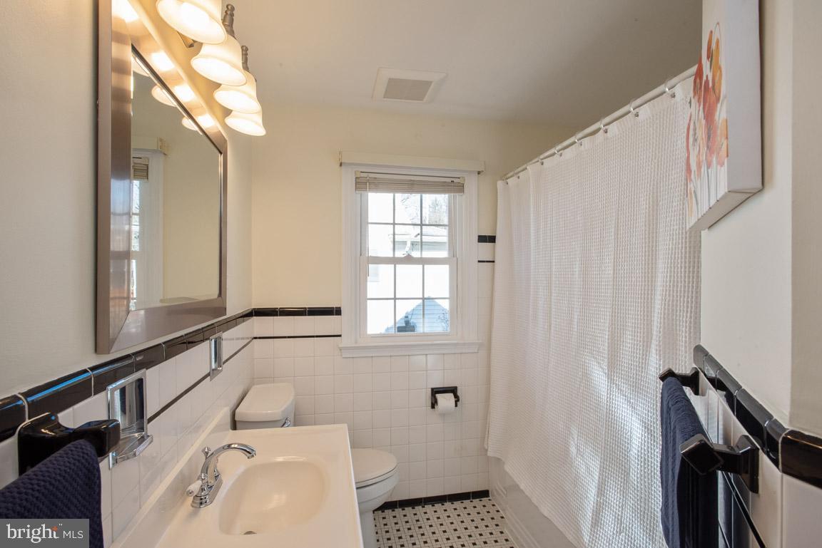 304 Cedarcroft Road Baltimore, MD 21212 - Photo 32 of 39 a bathroom with a sink a toilet and a window