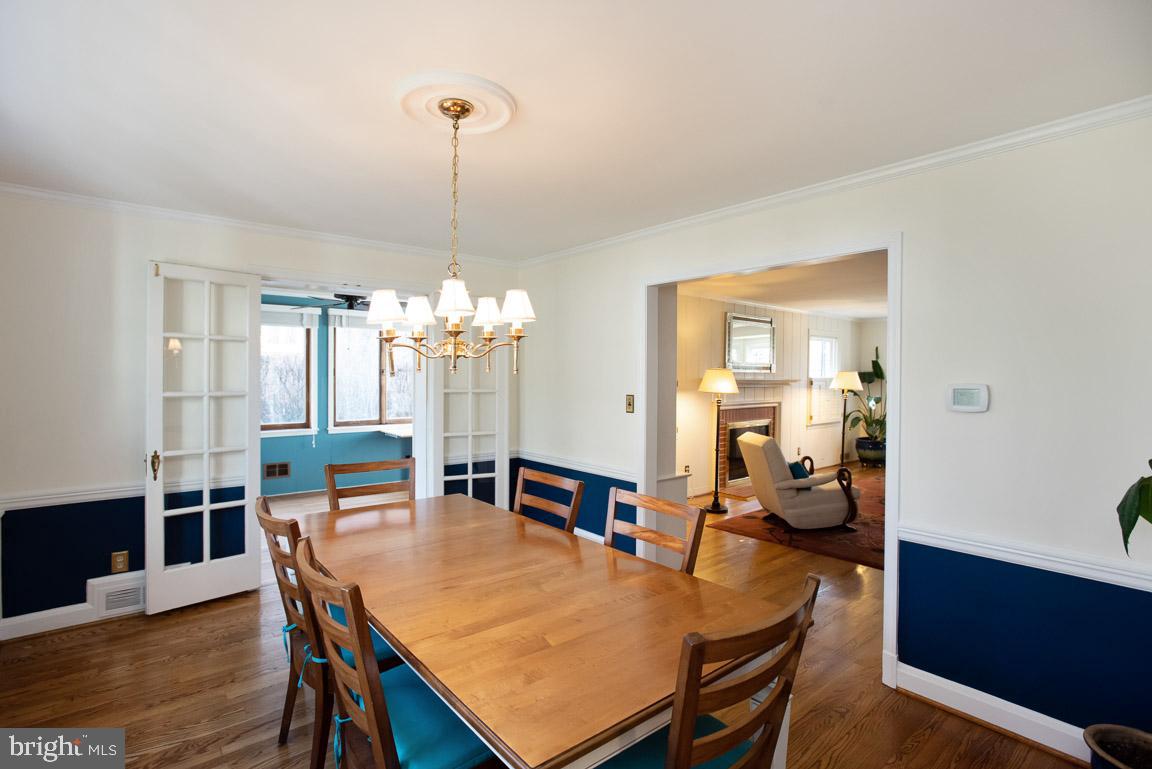 304 Cedarcroft Road Baltimore, MD 21212 - Photo 10 of 39 a dining room with furniture a chandelier and wooden floor