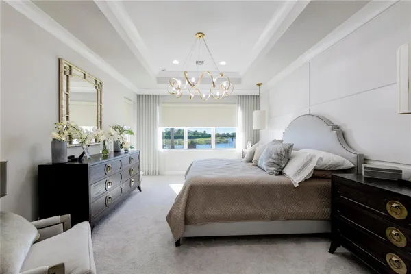 a bedroom with a bed and a chandelier