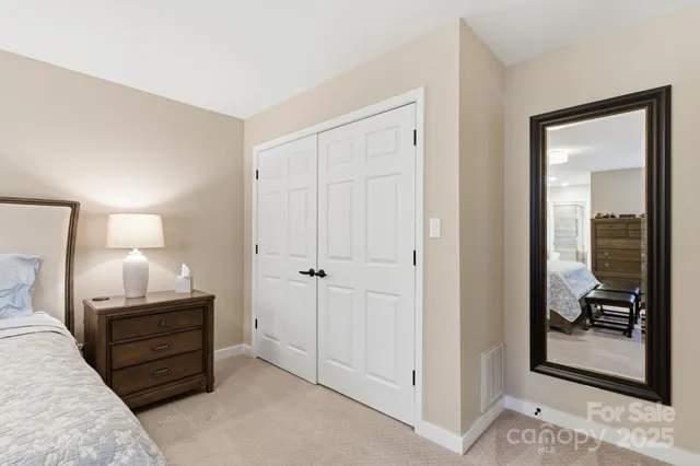 a room with a bed and a mirror