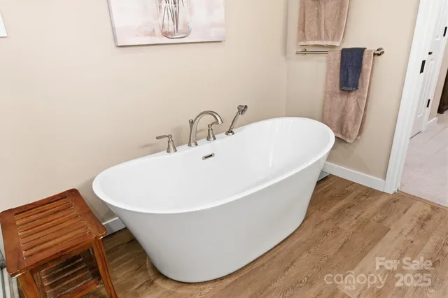 a white bath tub sitting next to a white sink