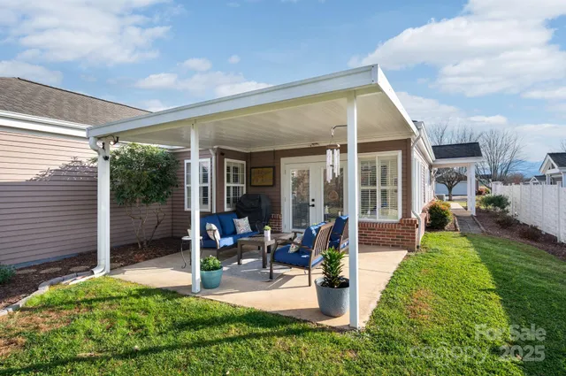 a view of a house with backyard porch and sitting area