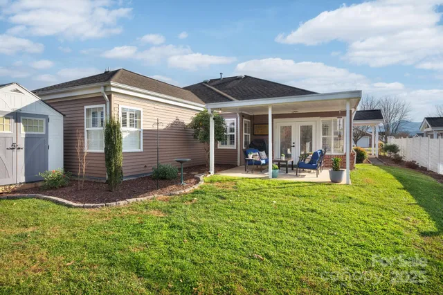 a view of a house with a backyard porch and sitting area
