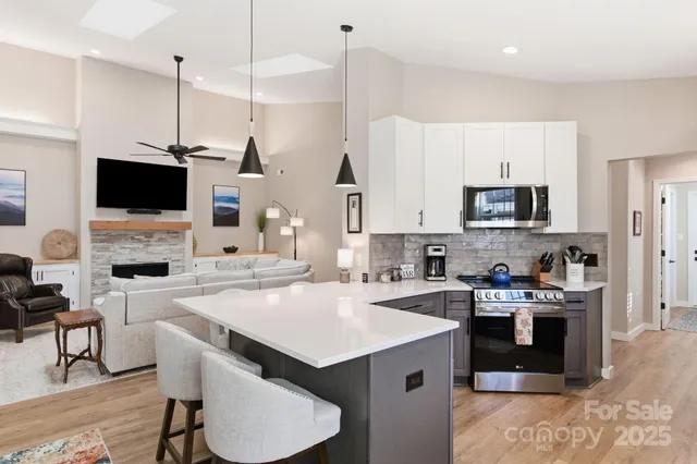 a kitchen with a sink a stove and chairs