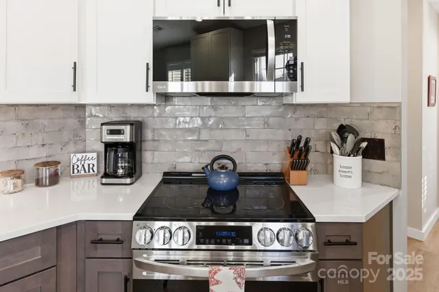 a stove top oven sitting inside of a kitchen