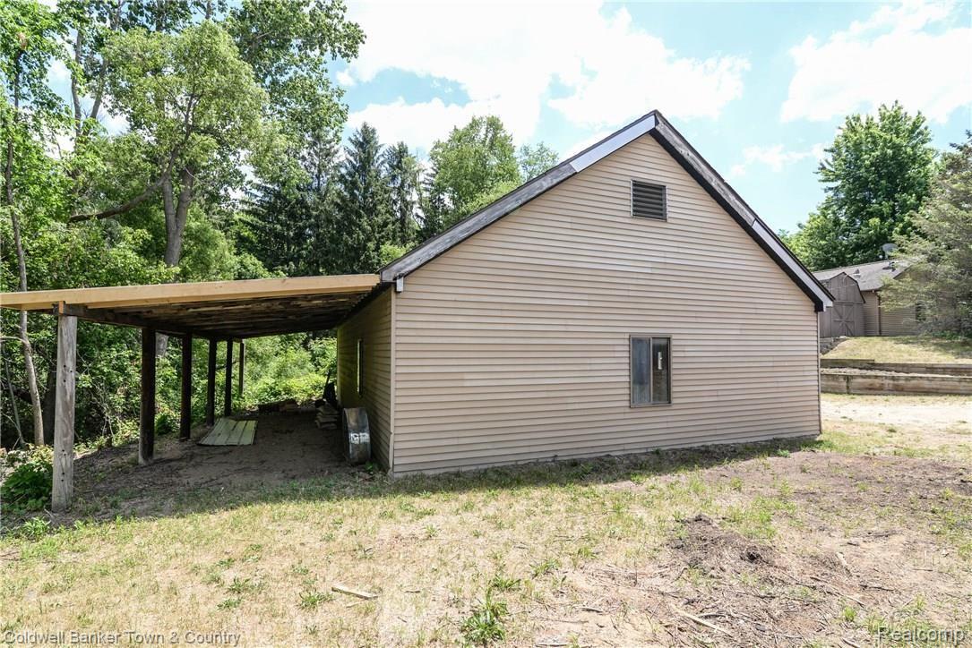 3210 Chase Lake Road Howell, MI 48855 - Photo 4 of 38 Side of pole barn with lean-to