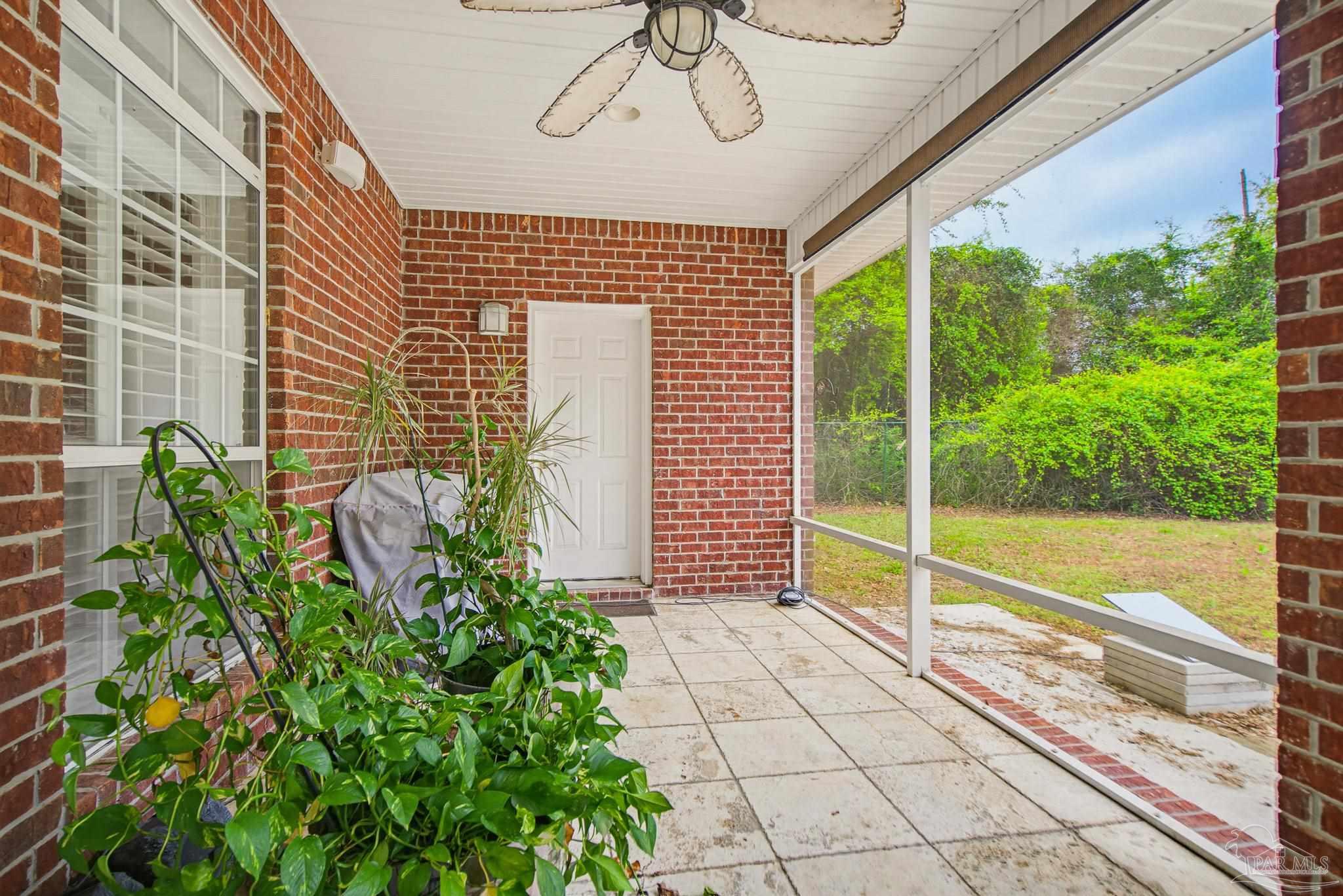 2855 Walling Road Milton, FL 32570 - Photo 47 of 55 a view of a porch with a floor to ceiling window next to a yard
