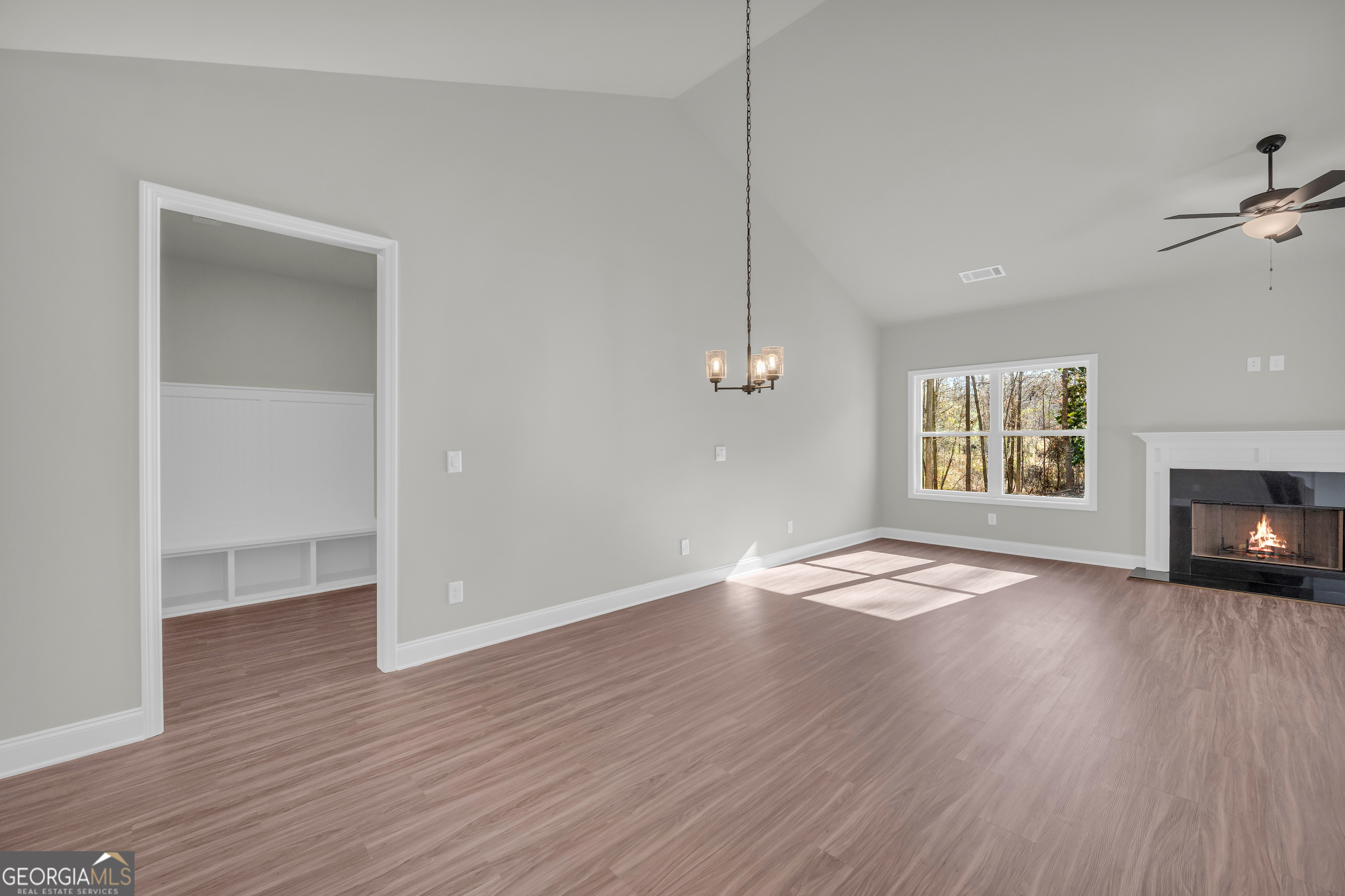 174 Old Milltown Road Hartwell, GA 30643 - Photo 16 of 53 a view of an empty room with wooden floor fireplace and a window
