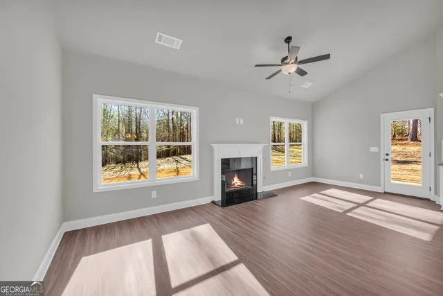 a view of kitchen with refrigerator microwave and wooden floor