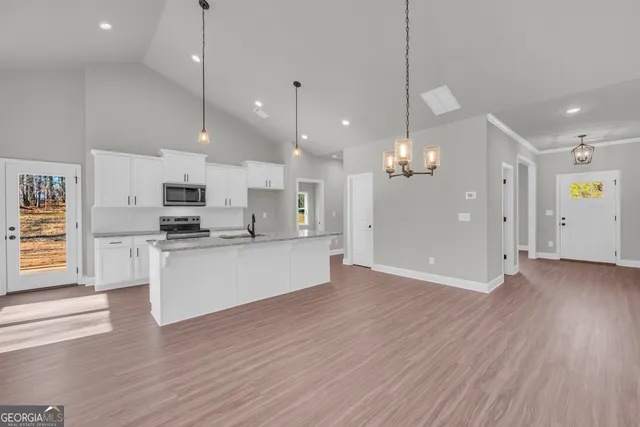 a view of a kitchen with wooden floor and a kitchen