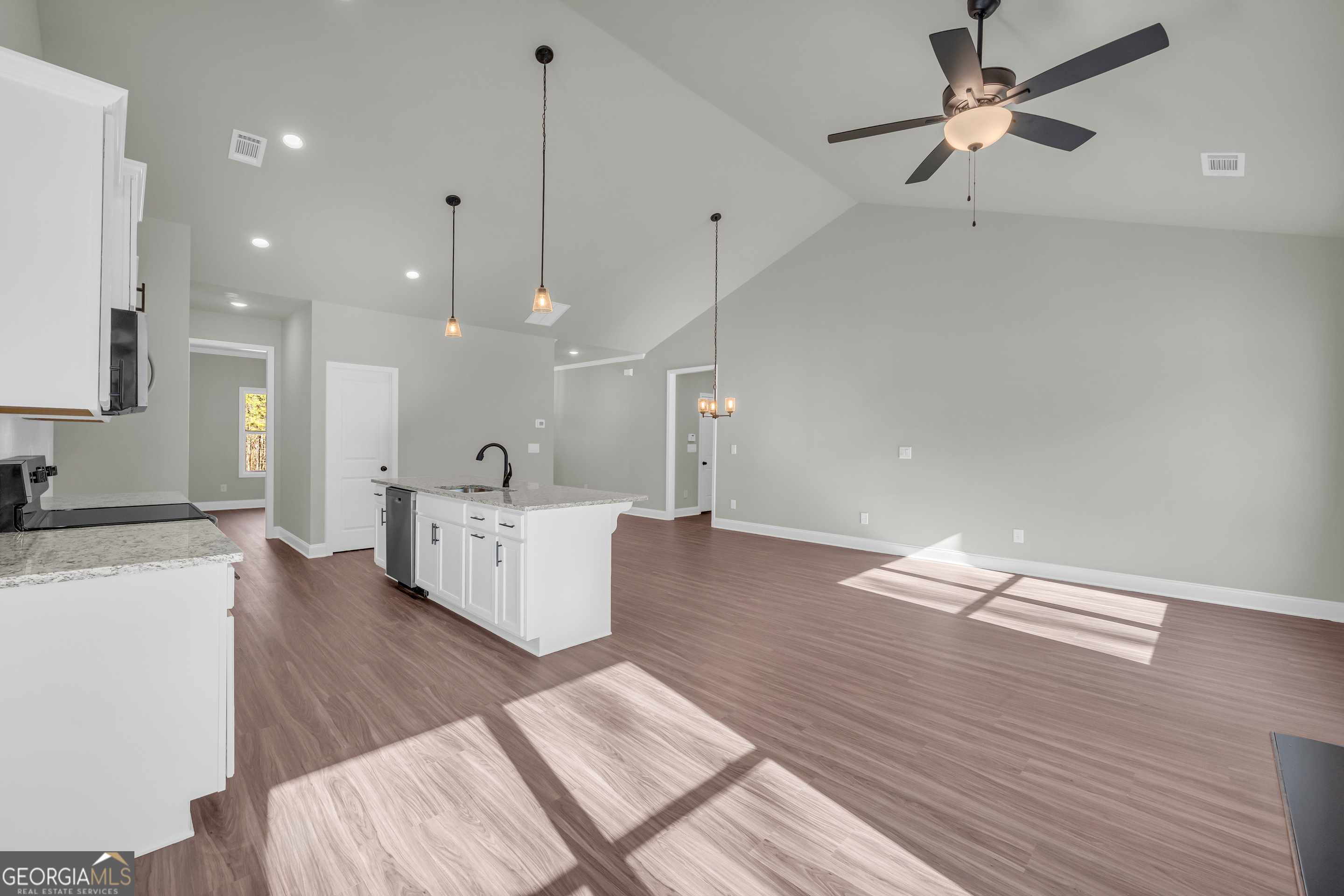 174 Old Milltown Road Hartwell, GA 30643 - Photo 20 of 53 a open kitchen with kitchen island a stove a sink dishwasher a refrigerator and white cabinets with wooden floor