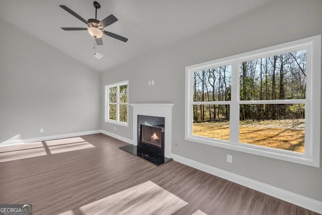 a kitchen with stainless steel appliances granite countertop a sink a stove and a wooden floors
