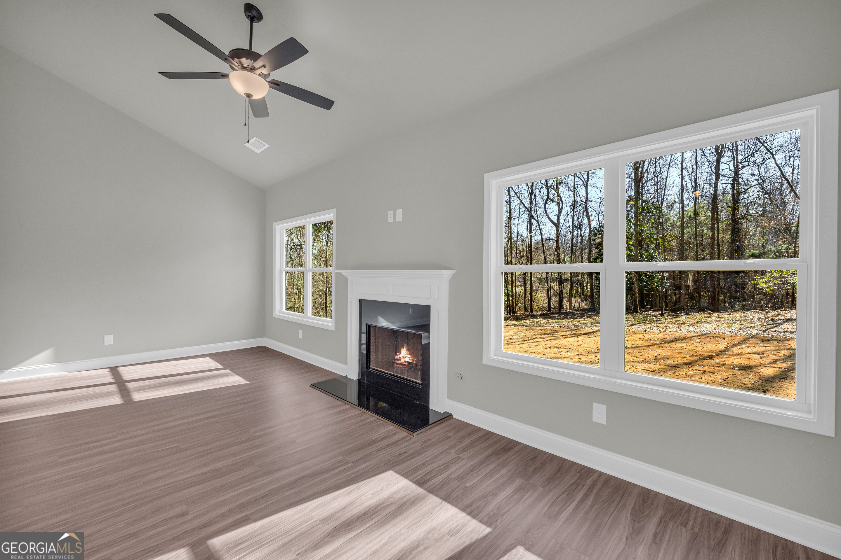 174 Old Milltown Road Hartwell, GA 30643 - Photo 21 of 53 a view of an empty room with a window and wooden floor