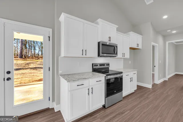 a kitchen with a sink stove and cabinets