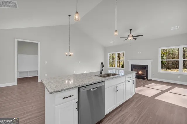 a kitchen with granite countertop cabinets stainless steel appliances and a window