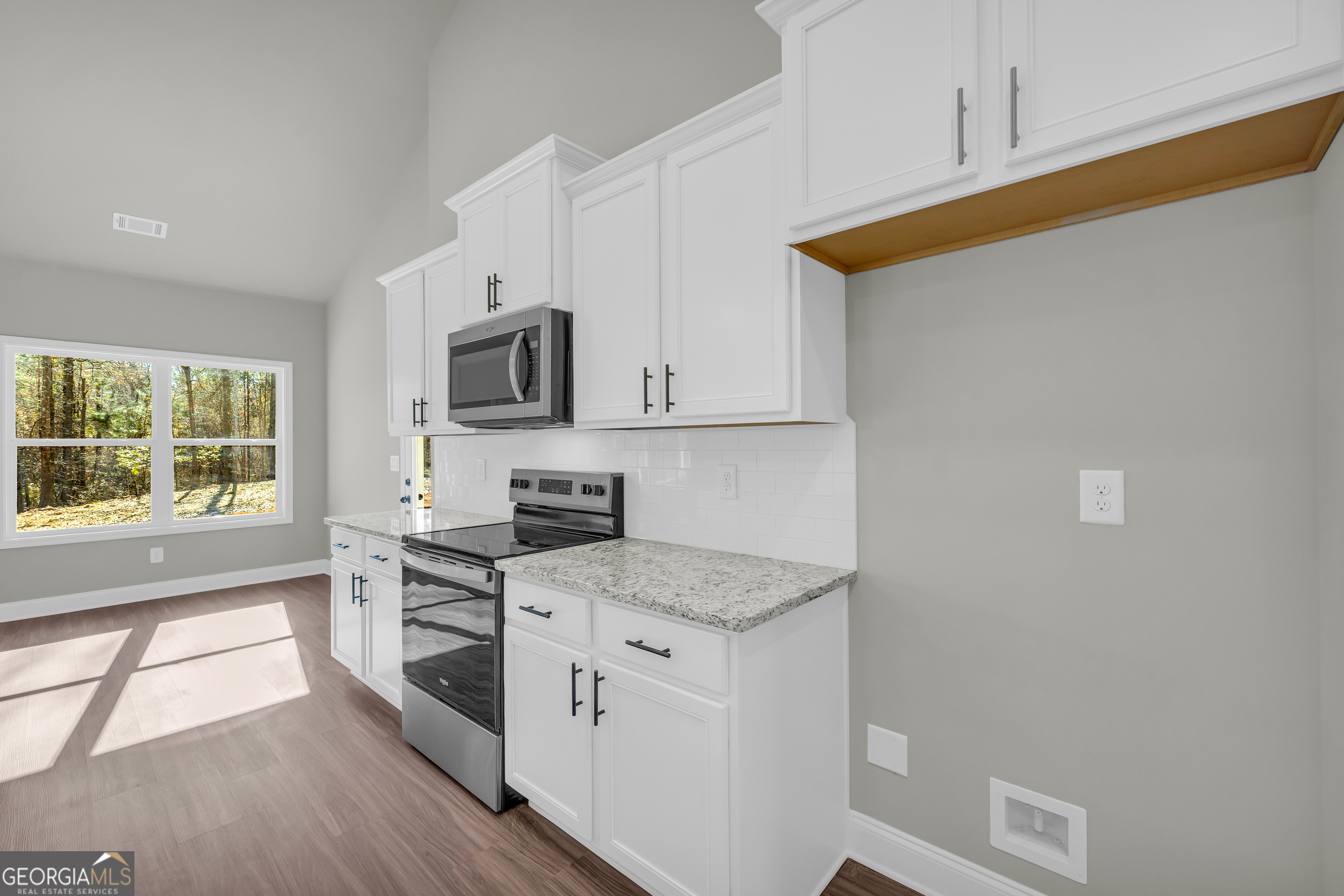 174 Old Milltown Road Hartwell, GA 30643 - Photo 26 of 53 a kitchen with granite countertop cabinets stainless steel appliances and a window