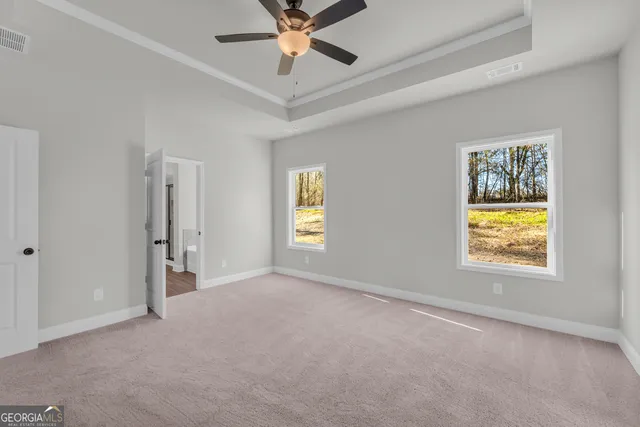 a view of an empty room with a ceiling fan