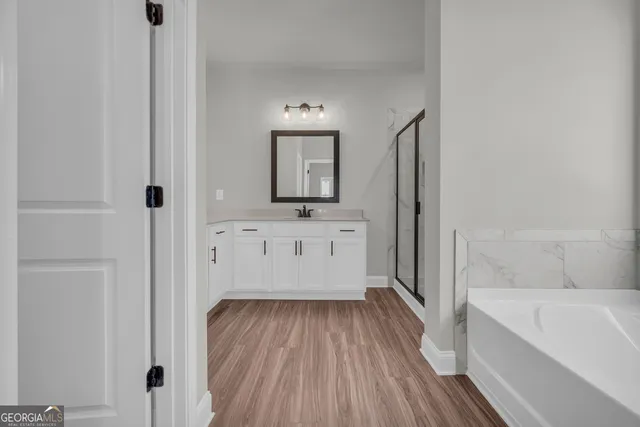 a bathroom with a bathtub and a sink
