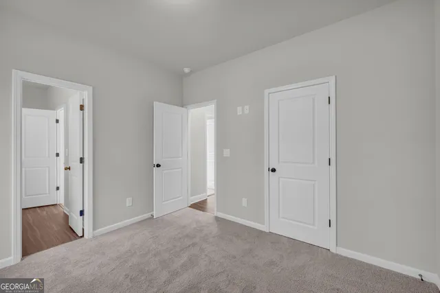 a bathroom with a toilet a sink a mirror and vanity