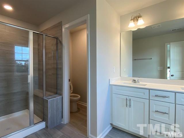 632 Gimari Drive Wake Forest, NC 27587 - Photo 13 of 18 a bathroom with a double vanity sink and a mirror