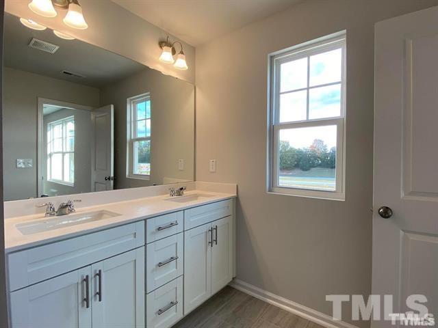 632 Gimari Drive Wake Forest, NC 27587 - Photo 16 of 18 a bathroom with a granite countertop sink mirror and double