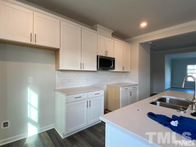 632 Gimari Drive Wake Forest, NC 27587 - Photo 4 of 18 a kitchen with cabinets appliances and a sink