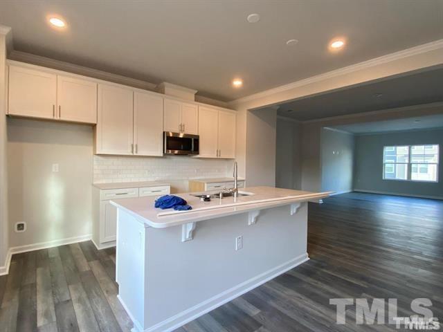 632 Gimari Drive Wake Forest, NC 27587 - Photo 6 of 18 a kitchen with stainless steel appliances granite countertop a sink stove and cabinets