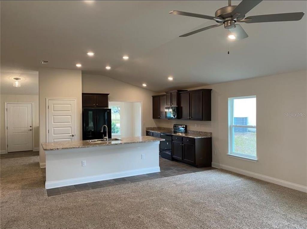 a view of a kitchen with a sink and a stove top oven
