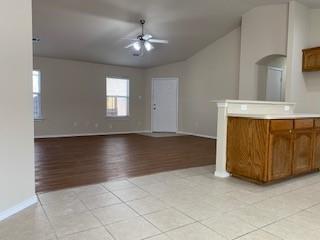 6421 Geneva Lane Fort Worth, TX 76131 - Photo 2 of 18 an empty room with a fireplace and chandelier