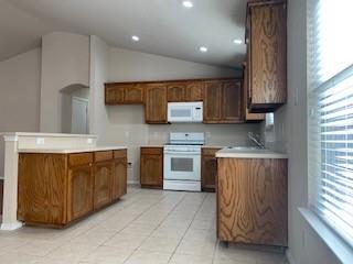 6421 Geneva Lane Fort Worth, TX 76131 - Photo 5 of 18 a kitchen with stainless steel appliances granite countertop a stove a sink and a microwave