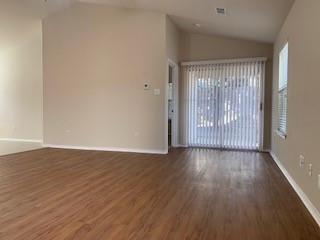 6421 Geneva Lane Fort Worth, TX 76131 - Photo 6 of 18 a view of an empty room with wooden floor and a window