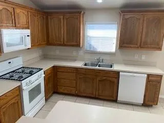 a kitchen with stainless steel appliances granite countertop a sink counter space cabinets and a sink