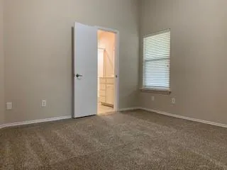 a kitchen with granite countertop wooden cabinets and white appliances